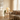 Linen sofa corner with knit throw, warm table lamp and trailing plant