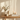 Oak console styled with cream ceramic vessels, dried eucalyptus, books and candles